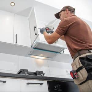 Contractor Worker Assembling of New Apartment Kitchen Cabinets